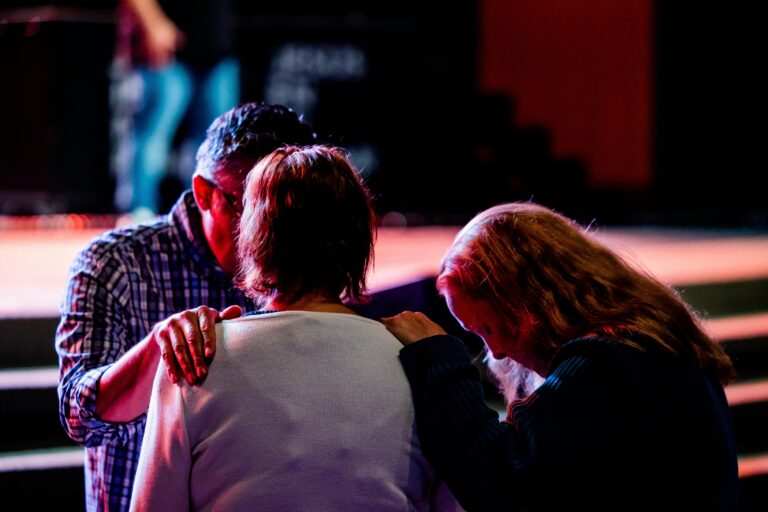 Group of Christians praying together in church.